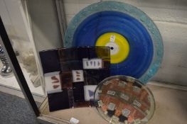 Three large colourful glass dishes.