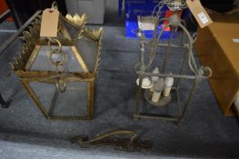 Two hall lanterns and a brass door handle.