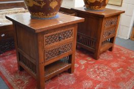 A pair of hardwood two drawer, two-tier bedside chests with carved decoration.