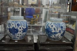 A pair of Chinese blue and white jars and covers.
