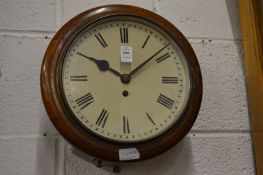An oak cased circular wall clock.