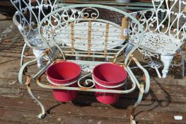 A miniature wrought iron garden bench double planter.