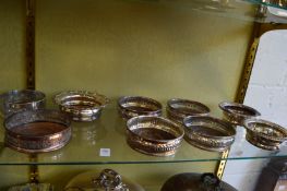 Three pairs of plated decanter coasters and three odd coasters.