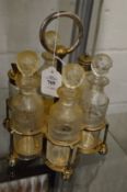 A six bottle cruet with plated stand.