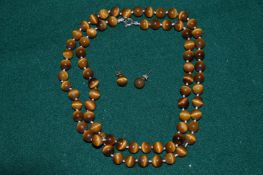 A tigers eye bead necklace and a pair of matching ear studs.