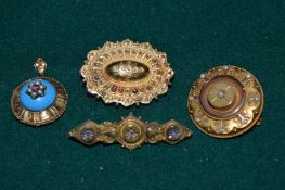 Three Victorian yellow metal brooches together with a similar pendant with blue enamel decoration.