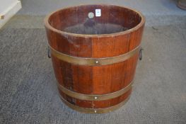 A brass bound teak jardiniere.