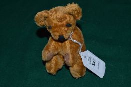 A miniature Merry Thought teddy bear.