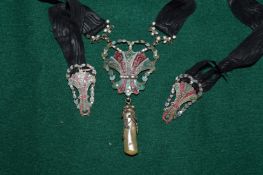 An enamel pendant suspended from a ribbon.