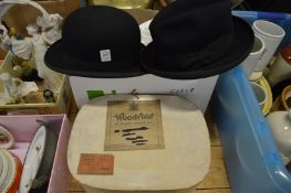A boxed bowler hat another hat.