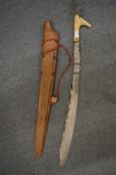 A Dayak Mandau head hunters sword and scabbard.