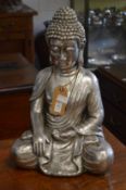 A large silvered resin model of a seated Buddha.