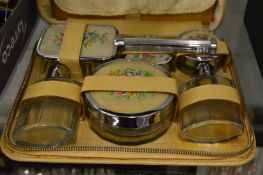 A cased toiletry set.