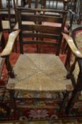 A 19th century ash and rush seated ladder back armchair.