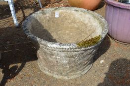 Two large weathered composite garden planters.
