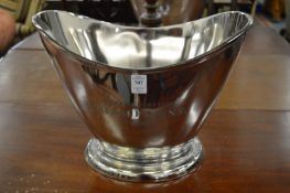 A pair of cast metal twin handled champagne coolers with engraved decoration.