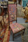 A Victorian rosewood framed high back chair with needlework upholstered back panel and seat.