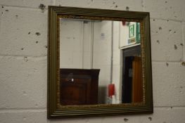 A small decorative square shaped mirror.
