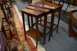 A nest of mahogany tables.