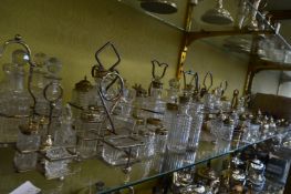 A large collection of silver plated and cut glass cruets and associated items.