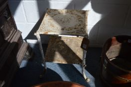 A small white painted cast iron two-tier stand.