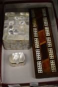 A cribbage board and two mother of pearl boxes.
