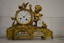 A French ormolu mantel clock with decorative porcelain panels.