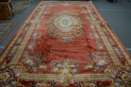 A VERY GOOD LARGE CHINESE CARPET, pink ground with all-over floral decoration. 700cms x 368cms.