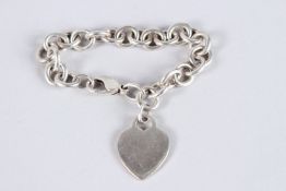 A TIFFANY & CO SILVER BRACELET with heart shaped lock.
