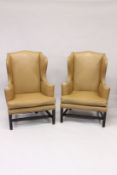A PAIR OF LEATHER WING ARMCHAIRS.
