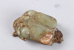 A CARVED JADE LOCUST in rock form. 3ins long.