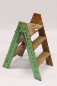 A SET OF WOODEN CHAMPAGNE FOLDING STEPS. 2ft 9ins high.