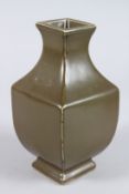 A CHINESE PORCELAIN TEA DUST GLAZED PORCELAIN VASE of square baluster form, six character mark to