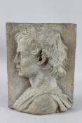 AFTER THE ANTIQUE A CARVED COMPOSITION PLAQUE of a young boy's head. 14ins x 10ins.