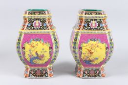 A PAIR OF COLOURFUL CHINESE BLUE GROUND OCTAGONAL VASES. 10ins high.