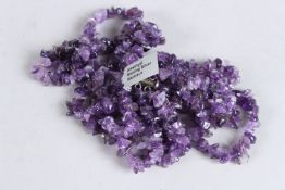 A LONG AMETHYST AND STERLING SILVER NECKLACE.