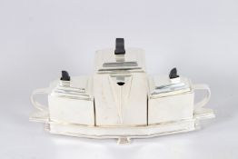 AN ART DECO DESIGN PLATED THREE PIECE TEA SET on stand.