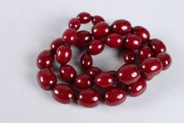 A STRING OF AMBER BEADS.