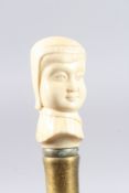 A WALKING STICK with a carved bone lady's head.