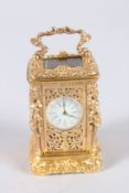 A GOOD SMALL CAST GILT METAL CARRIAGE CLOCK, the sides with figures. 2.5ins high.