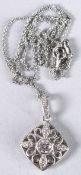 AN ORNATE SQUARE SILVER PENDANT set with white cubic zirconia, on a silver chain.