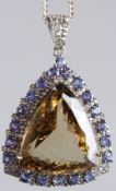 A LARGE SILVER PENDANT set with triangle-cut citrine, tanzanites and diamonds on a silver chain,