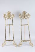 A LARGE PAIR OF BRASS PICTURE EASELS. 2ft 8ins long.