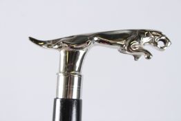 A WALKING STICK with a chrome jaguar.