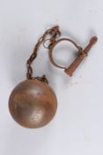 A CAST IRON BALL AND CHAIN.