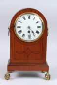 AN EDWARDIAN MAHOGANY MANTLE CLOCK on claw and ball feet. 13ins high.