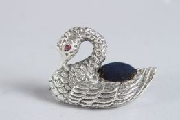 A SILVER RUBY EYE SWAN PIN CUSHION.