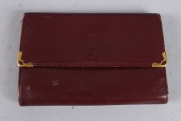 A CARTIER LEATHER FOLDING PURSE / WALLET.