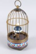 A MINIATURE REPLICA BIRD IN A CAGE CLOCK. 8ins high.