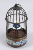 A REPLICA MUSICAL BIRD IN A CAGE. 7ins high.